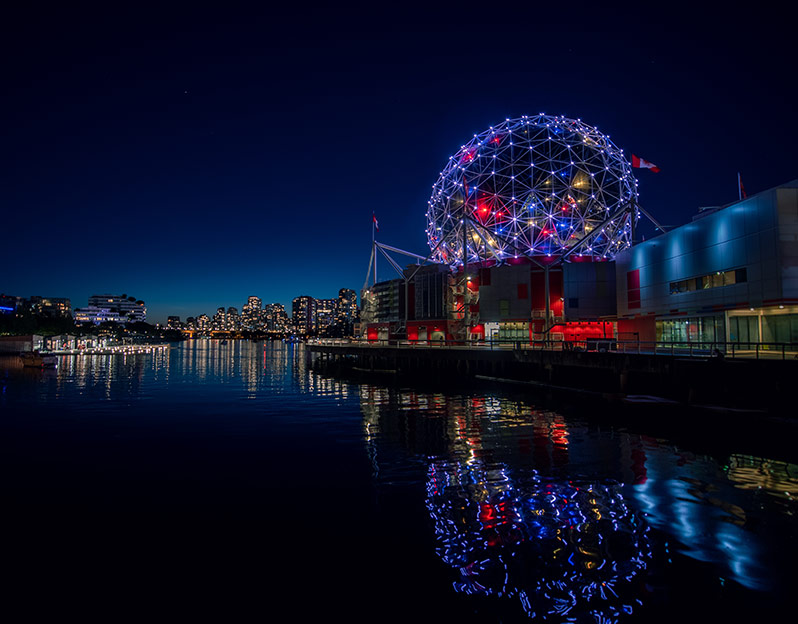 Looking across at the science world lights and reflection in the water with Vancouver in the background at night