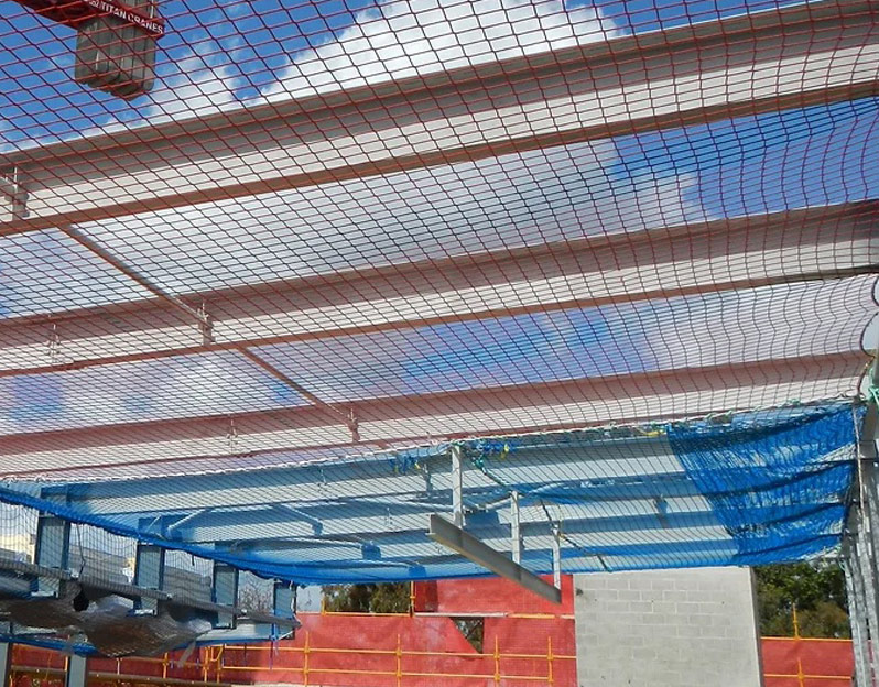 Looking up at an open rooftop with fall protection netting installed below